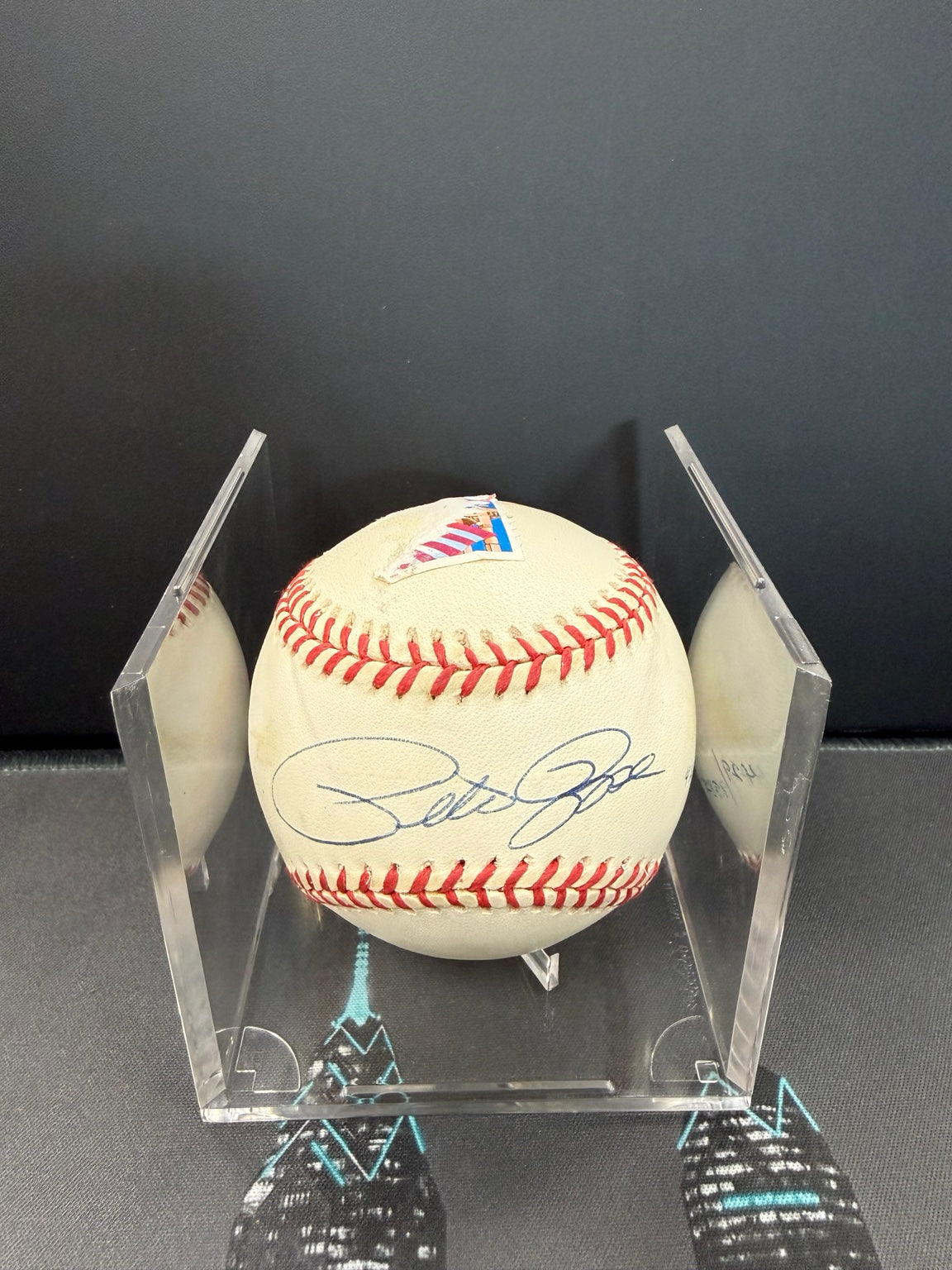 Pete Rose autographed baseball in acrylic display holder